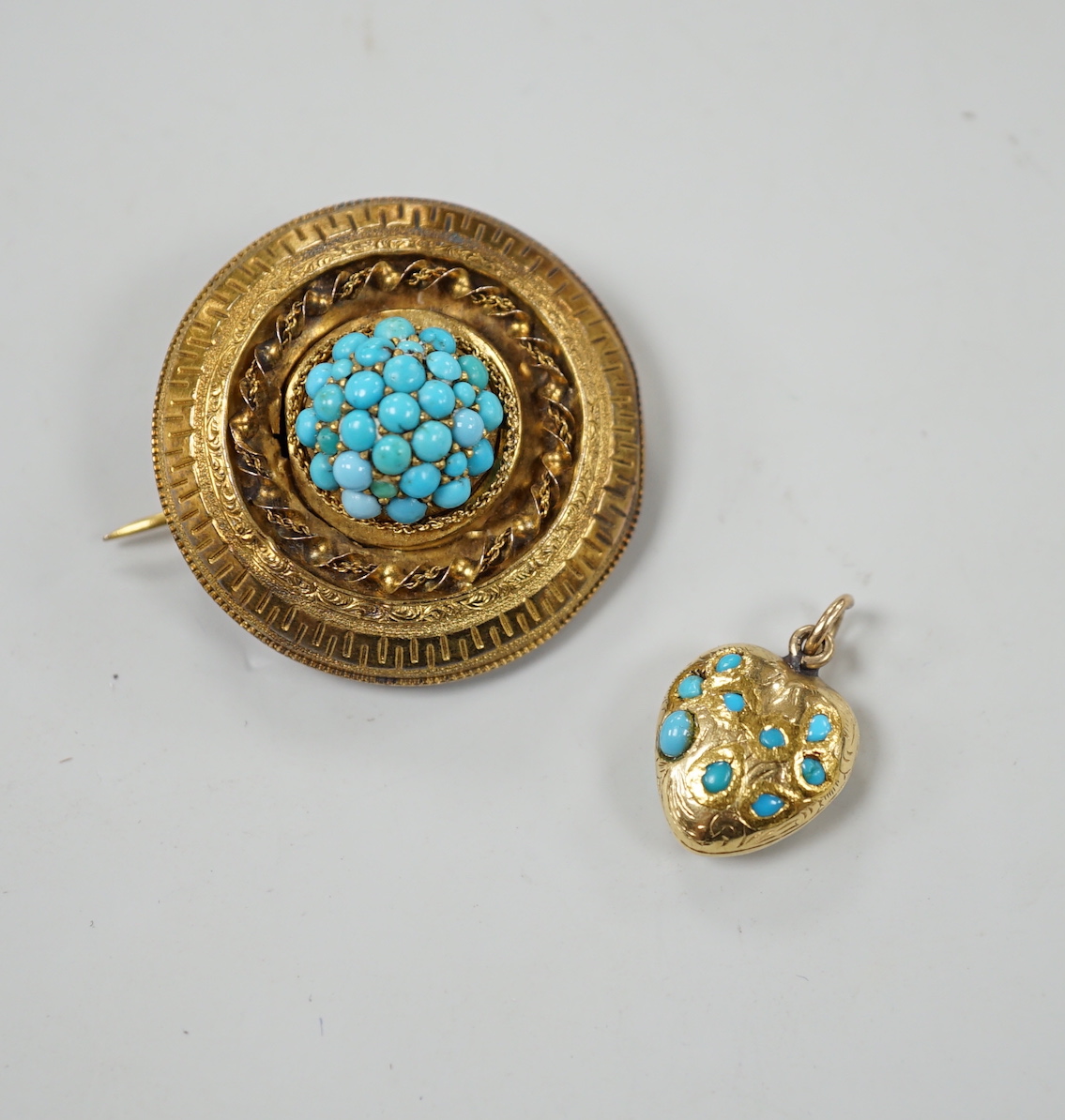 An Edwardian yellow metal and turquoise cluster set heart pendant, 16mm, together with a larger gilt metal and turquoise set brooch.